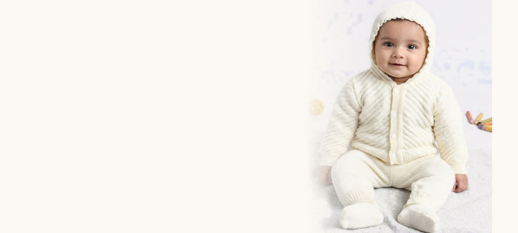 Baby in a cream hooded knit set by Little Angels